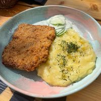 Polish schabowy with mashed potatoes and mizeria salad at Bracka 20 in Warsaw