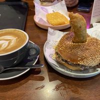 Soy flat white, hash brown and vegan burger with sesame seed bagel   at Balls and Bangles in Queenstown