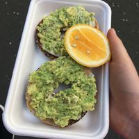 Avo bagel with vegan cream cheese underneath  at Hussey & Laredo in Dunedin