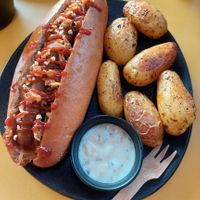 "Le Maple Joe" (seitan sausage, maple syrup, hazelnuts, mustard onions, BBQ sauce) with baked potatoes and a sour cream dip at Not Dog in Nice