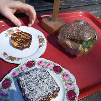 Vegan Snickers cake, chocolate cake and hummus bread roll at Caféet i Tyresta By in Vendelsoe
