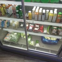 Fridge with juices and kombucha and sprouts & more at Delicious Food in Amsterdam