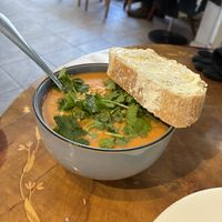 Peanut sweet potato soup and fresh coriander with bread  at Roihuvuoren Rio in Helsinki