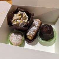 Box of incredible treats. Brownie with panna, creme filled doughnut, vanilla roll, delicious chocolate tower thing I forget the name of. at Leccornie in Milan