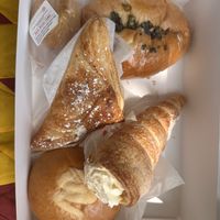 Upper left red bean cake, upper right spring onion bun, middle apple turnover, lower left lemon custard bun, lower right butter cream cone.   at Keefer Court in Eden Prairie