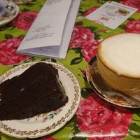Vegan chocolate cake (from specials board) and cappuccino with alpro barista oat milk at Shakespaw Cat Cafe in Stratford-upon-avon
