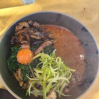 steaming hot bowl spicy tantanname ramen, sesame, szechuan pepper, spinach, tomato egg, spinach, and tofu oh my at Umami Ramen & Izakaya in Montreal