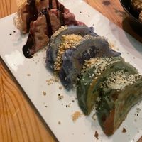 Gyoza platter, dough is hand dyed with all natural colorants. Filled with potato and soy (beet), Cashew cheese and greens (blue pea pod), Edamame and shiitake (spirulina) at Plant Based Sushi in Amsterdam