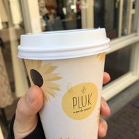 Delicious soy matcha latte in a cute cup 🌻  at Pluk in Amsterdam