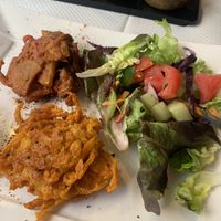 On the top Pakora and below Oignon Bhaja (shared with my husband). Let them know your vegan because of the salad dressing.   at Le Penjab in Saint-malo