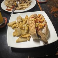Dirty dog with fries (nachos from specials board in background)  at Filthy Vegan in Ho Chi Minh City