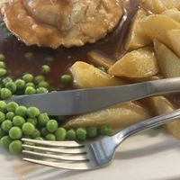 Chicken and mushroom pie with peas, chips and gravy  at Filthy Vegan in Ho Chi Minh City