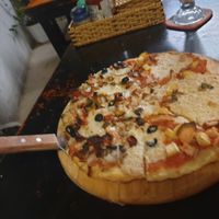 Pizza half and half veggie and 'meat'  6/10 toppings great base left more to be desired at Filthy Vegan in Ho Chi Minh City