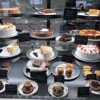 case full of amazing cakes and other desserts 😍 at How Delish HD in West Orange