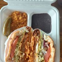 Cowboy torta with a side of beans and rice  at Nuno's Tacos & Vegmex Grill in Dallas