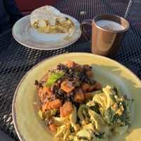 Tofu scramble and sweet potato hash front, breakfast burrito behind  at The Park Side Cafe in Olympia