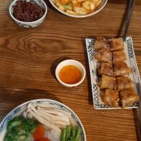 Sping rolls, peanut tofu, brown rice, rice noodle soup bowl at Ngon Vegan Restaurant in Tam Coc