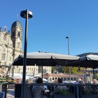 Outdoor seating with view of monastery at Tulipan in Einsiedeln