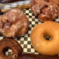 Eclairs, Apple fritters, plain glazed and blueberry maple donuts at Mmm Donuts in Barrie