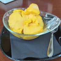 Two scoops of mango ice cream, the only vegan flavor available at the time at News Cafe in Portoroz