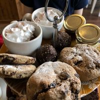 Cookies, biscuits (or scones?) chocolate pudding with whipped cream on top, jam, and margarine. at Luna's Vegan Corner in Cardiff