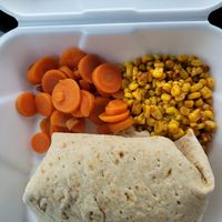 Maizys Meaty Black Bean and Pecan Wrap with cooked carrots and street corn at Frannie's Vegan Cafe in Johnson City