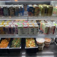 Cold case with drinks and salad. at Watercourse Foods in Denver