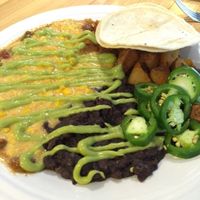 BREAKFAST BURRITO (Refried black beans and your choice of home fries, sweet potatoes, or rice, wrapped in a tortilla and smothered with gravy or green chili) at Watercourse Foods in Denver