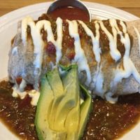 BREAKFAST BURRITO (Refried black beans and your choice of home fries, sweet potatoes, or rice, wrapped in a tortilla and smothered with gravy or green chili) at Watercourse Foods in Denver