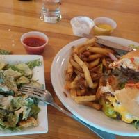 Sink your teeth into this luscious Classic Burger and Fries -- side Caesar salad, and lunch is complete! at Watercourse Foods in Denver
