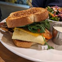 Breakfast sandwich with side salad at Watercourse Foods in Denver