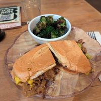 Cuban sandwich with side of broccoli, ginger beer in the background. at Watercourse Foods in Denver