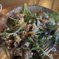Country strips on top of a summer salad with ranch dressing. For the weekend brunch these are known as battered plain seitan wings.  Combined they make an incredible salad!   at Watercourse Foods in Denver
