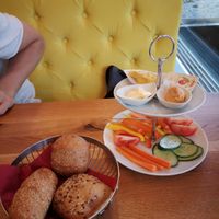 Fresh bread rolls with 2 types of homemade hummus, vegan butter, jam and fresh veggies at Cafe Galerie in Dornbirn
