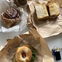 salmon and cream cheese bagel, bacon and nae egg breakfast sandwich and cinnamon roll  at Black Rabbit in Edinburgh