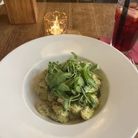 Gnocchi with basil sauce, dried tomatoes and arugula.   at Maitrea in Prague