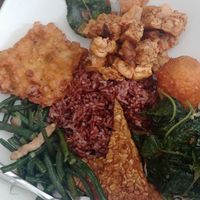 I chose brown rice, with local greens, beans-with-tempeh, fried tempeh, corn fritter, egg, fried tempeh-tofu-curry leaves, for 37K. at Bu Mi in Canggu