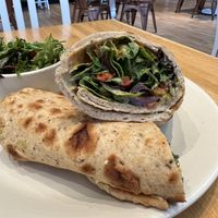 Mediterranean Wrap- hummus, spicy herb sauce, red pepper pistachio spread, cucumber, olives, artichoke, organic spring mix, lemon oregano vinaigrette  at True Food Kitchen in Jacksonville