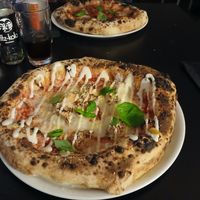 4 cheese pizza in the foreground, Mamma rossa in the background at Plant A Pizza in Ghent