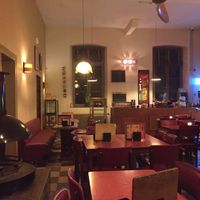 Nice retro interior with fireplace at Café Modern in Voeren