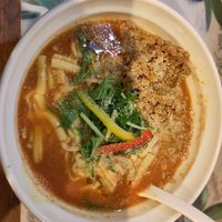 Tomato curry soup with extra soy meat and vegan cheese, I'm happy I got the extra toppings otherwise it's basically just noodles and broth. at Fuku Noki in Sapporo