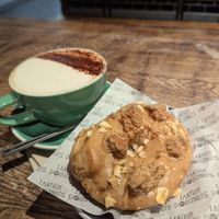 Banana Foster ring doughnut and oat cappuccino at Tantrum Doughnuts in Glasgow