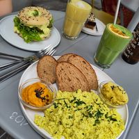 Tofu scramble, egg salad bagel, gold and green smoothie at Plant Base in Berlin