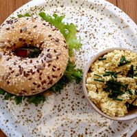Bagel with hummus and dried tomatoes and tofu scramble 🥰 at Plant Base in Berlin