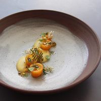 *Fresh Tomato - Tomato, Preserved Garlic Scape, Spelt, Mint. One Course from the 13-Course Vegan Tasting Menu. at ēst in Toronto