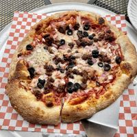 Dairy free cheese, plant based hamburger, olives, onions and the delicious house red sauce    at Brick Oven Pizzeria in Omaha