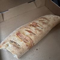 Calzone with soy cheese, vegan sausage, pineapple and jalapeño  at Brick Oven Pizzeria in Omaha