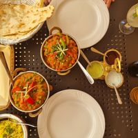 Plain naan, two mains, rice with peas and left over sauces from popadams at Gate of India in Krakow