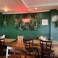 Interior dining area, neon sign says MAKE TACOS NOT WAR at Treehouse Taqueria in Ogunquit