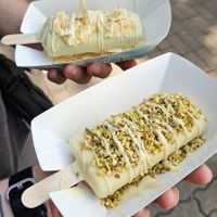 Top: Pistachio dipped in white chocolate and topped with coconut flakes. Bottom: Vanilla bourban and pecan, dipped in white chocolate and topped with pistachio at Anjuna Ice Pops - Pozsonyi Ut in Budapest